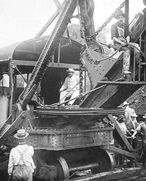 Photo of President Theodore Roosevelt sitting on a steam shovel at the Panama Canal