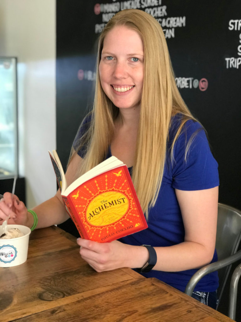 Brooke reading The Alchemist while eating ice-cream.